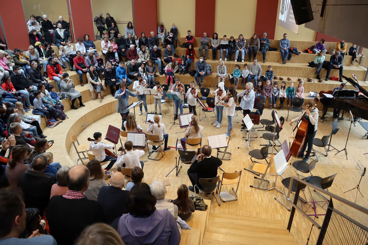 Schüler mit Instrumenten vor Publikum im Forum